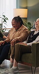 Friends, relax and laughing with old women on sofa in home for reunion, bonding or funny joke. Get together, comedy and connection with senior people in living room of house for gossip and retirement