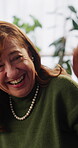 Friends, talk and laughing with old woman on sofa in home for reunion, bonding or funny joke. Get together, comedy and connection with senior people in living room of house for gossip and retirement