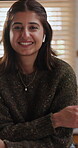 Arms crossed, face and happy woman with earphones in kitchen, pride and streaming with subscription. Confident, portrait and person with tech on break, entertainment and listening to music in home