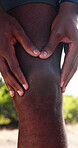 Fitness, exercise and person with hands on knee outdoor for injury, pain or muscle fatigue on run. Runner, man and massage leg in nature for osteoporosis, arthiritis or joint problem on workout