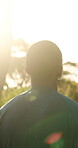 Running, fitness and back with black man in nature for workout, cardio challenge and sports athlete. Training, exercise and runner wellness with person outdoor for performance, endurance and flare