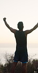 Winner, runner and back of man in nature for workout break, fitness goal and celebration. Exercise rest, success and wellness with person outdoor for health, endurance training and achievement