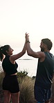 Couple, running and high five on mountain with sea view, fitness goals and finish cardio training. Happy, married people and outdoor with hug, celebration or complete exercise with ocean scenery.
