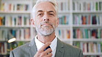 Face, history and tie with man in library for archives, book collection or research. Confident, information and smart with mature historian in bookstore for fact verification, findings or studying