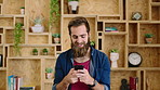 Man, typing or happy with phone for communication, social media or connection in home. Male person, creative or user texting with smile on mobile smartphone for network, internet or online chatting