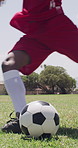 Legs, player and kicking ball for soccer, fitness and match practice for outdoor competition. Feet, person or action on field for football, game day and tactical play with skills for sports challenge