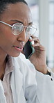 Doctor, telehealth and black woman with phone call in office for health advice or medical help. Female person, healthcare worker or discussion with mobile smartpone for communication in hospital