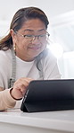 Cooking, tablet and senior woman with recipe, online instruction or tutorial for meal prep in home. Kitchen, tech and person for research, lunch ideas and inspiration on culinary website or food blog