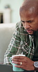 Coffee, laptop and black man in home with remote work for finance report with budget planning. Warm beverage, computer and African male financial manager with freelance career for investment in house