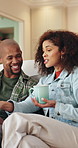Couple, coffee and relax on sofa with smile, bonding and connection with conversation  in living room. African people, happy and chat on couch with warm beverage, relationship and drink in lounge