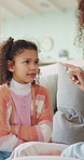 Mom, girl and scold on couch with point, discussion and guide for discipline in living room at house. People, mother and daughter for talk, warning or rules with child for bad behavior at family home