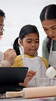 Family, baking and child in home with tablet, learning and dough recipe for homemade cookies. Mother, grandmother and teaching kid with digital for tutorial, instructions and measure flour for treats