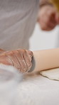 Hands, child and baking at house with dough, learning and culinary skills for homemade cookies. Person, rolling pin and teaching kid in home with pastry, family recipe and guidance for handmade bread