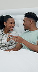 Cheers, hotel and black couple in bed with coffee, conversation and celebrate anniversary in morning. Marriage, happy and man with woman with drink for talking, love and toast for romance at resort