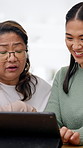 Teaching, senior mother and women with tablet in house, laughing and bonding with parent on weekend. Mature person, learning and digital literacy with tech, talking and listening to daughter in home