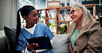 Caregiver, tablet or old woman with discussion on couch, explain results or advice for medical report. Tech, nurse or senior person with instructions for health care, wellness update or smile in home