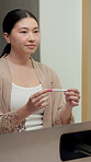 Mirror, pregnancy test and woman in bathroom, shocked an announcement with maternity news. Reflection, pregnant and Japanese person in home, fertility and perspective with decision, ivf and stick