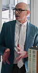 Businessman, realtor or meeting with property model in office for building or infrastructure. Man, employee or real estate agent with 3D apartment or prototype for construction plan or renovation