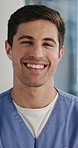 Nurse, face and happy man with confidence in hospital for medical assistance or healthcare service. Portrait, male person or health worker with smile or arms crossed for clinical help, care or aid