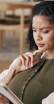 Confused, tablet and woman on sofa in home with reading online blog in living room on weekend. Thinking, doubt and female person with digital technology for ebook or article on app in apartment.