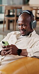 Dance, phone or black man in house with headphones, song connection or listening to music playlist. Happy, sound track or person on sofa with tech, feeling beat or radio subscription on audio app.