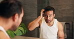 Grooming, man and check hair in mirror for beauty routine, hairstyle maintenance or self care. Reflection, morning and person with haircare in home bathroom for getting ready, dermatology or wellness