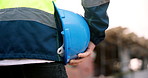 Hand, man and helmet on construction site for safety, development or building project. Technician, person or employee with hard hat for protection, engineering compliance or inspection for renovation