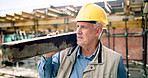 Mature, man or architect walking with concrete for building material on construction site. Male person, contractor or civil engineer with equipment or safety gear for structure or architecture plan