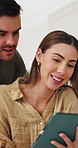 Tablet, scrolling and couple in home with texting, social media or funny meme on app in living room. Happy, digital technology and man with woman for reading comic blog online together in apartment.