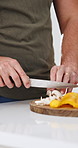 Cooking, hands and man with healthy food for nutrition, meal prep and cutting ingredients for lunch. Diet, vegetables and home chef in kitchen with knife, recipe and culinary skills with mushrooms