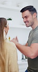 Love, playful or couple in kitchen with dance, romantic moment or bonding together on weekend break. Laughing, groove or people in house with movement, rhythm or fun connection in happy relationship.