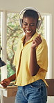 Headphones, happy and black woman in home with dance to music, playlist or radio online on weekend. Smile, audio tech and African female person with listening to album on app in living room at house.
