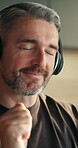 Music, home and man with headphones, dance and listening to jazz playlist on streaming service. Audio tech, moving and mature person with favorite song on radio, rhythm and happiness at apartment