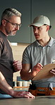 Man, plumber and customer with inspection in kitchen for home repair, quote or fixing cost. Male people, handyman or discussion with client for plumbing service, installation or consultation in house