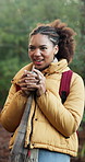 Backpacking, mindfulness and happy woman with coffee in nature, calm or thinking on peaceful holiday. Hiking, vacation and African person with smile, breathing and relax with warm drink in forest