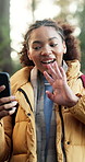 Hiking, wave and happy woman with phone for tutorial in forest for outdoor journey or adventure. Influencer, female person or vlogger with smile for online streaming, guide or trekking tips in nature