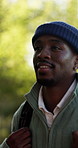 Happy, hiking and black man with backpack in nature for outdoor adventure, travel or sightseeing. Active, male person or hiker with smile or bag in forest for trekking journey or trip in wilderness