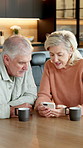 Old couple, reading and talking in home with phone, research and email for finance report. Smile, senior people and laugh at house with mobile, application and financial information for bank inquiry
