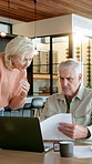 Old couple, reading and document at house with laptop, research or letter for finance expenses. Senior people, explain and paperwork in home with pc, financial invoice and payment for household bills