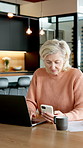 Old woman, reading and phone in home with laptop, research or statement for finance expenses. Senior person, coffee and typing at house with tech, financial comparison and payment for household bills
