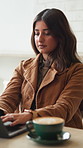 Coffee shop, typing and woman on laptop for remote work, copywriting and website content. Freelancer, restaurant and person on computer for research, article review and submission with cappuccino