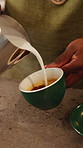 Pour, milk and hands of person in coffee shop, restaurant and prepare for customer order. Barista, hospitality and worker with caffeine process for espresso, cappuccino and latte art in cafeteria