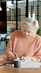 Old woman, writing and document in home with contract, signature and application for finance loan. Senior person, review and paperwork at house with policy, financial letter and agreement for payment
