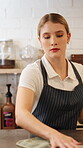 Hospitality, woman and cleaning in coffee shop with cloth, hygiene and maintenance for small business. Female person, wipe and polish counter in cafe for shine, work protocol and customer service.