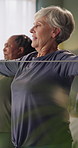 Senior, coach and women with resistance band for stretching, wellness and exercise for mobility together. Retirement, class and people with equipment for health, strength training and muscle workout