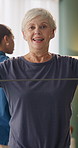 Senior, face and women with resistance band for health, wellness and exercise for mobility in class. Retirement, portrait and people with equipment for stretching arms, muscle strength and fitness