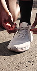 Fitness, hands and tying shoes on road outdoor to start training, wellness and practice preparation. Sneakers, person and runner fasten shoelace for getting ready, sports safety and health on street