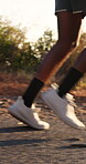 Fitness, legs and running with person outdoor for action, cardio training or wellness. Challenge, exercise and pace with runner on path in nature for development, improvement or workout routine