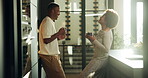 Coffee, laughing and morning with black couple in kitchen of home for bonding or connection. Drink, smile and talking with funny people in apartment for break, communication or relationship security