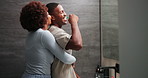 Love, happy couple and brushing teeth with hug, kiss or dental conversation by bathroom mirror. African man, woman and toothbrush at home for oral hygiene, embrace and gum care in morning routine